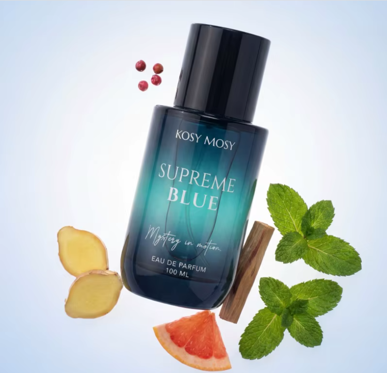 Supreme Blue perfume bottle with black cap surrounded by citrus, mint leaves and other decorative ingredients