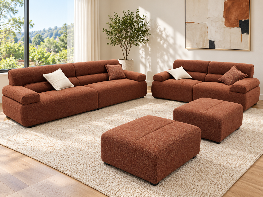 Ava sofa set in a living room — 3-seater, 2-seater and two ottomans in showroom rust upholstery