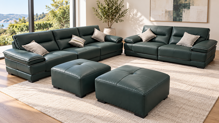 Olivia sofa set in a living room — two sofas and two ottomans in showroom green upholstery