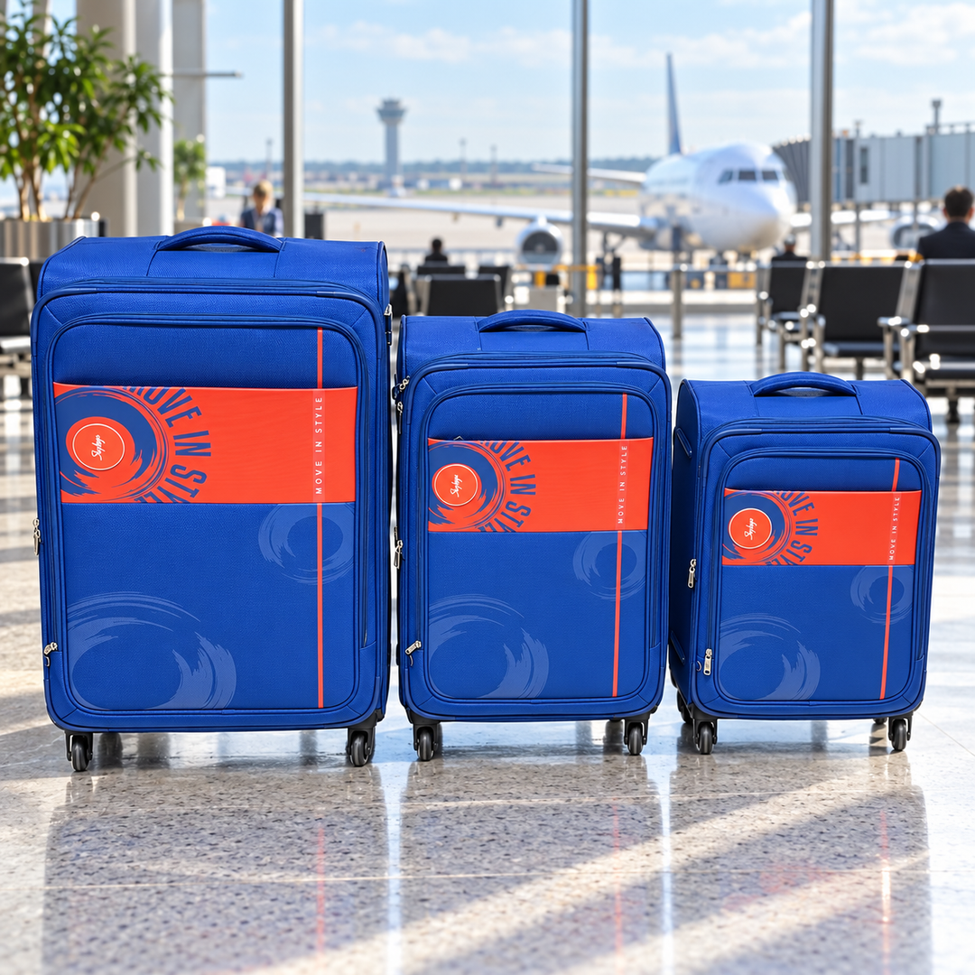 Blue and orange Skybags suitcases in an airport lounge