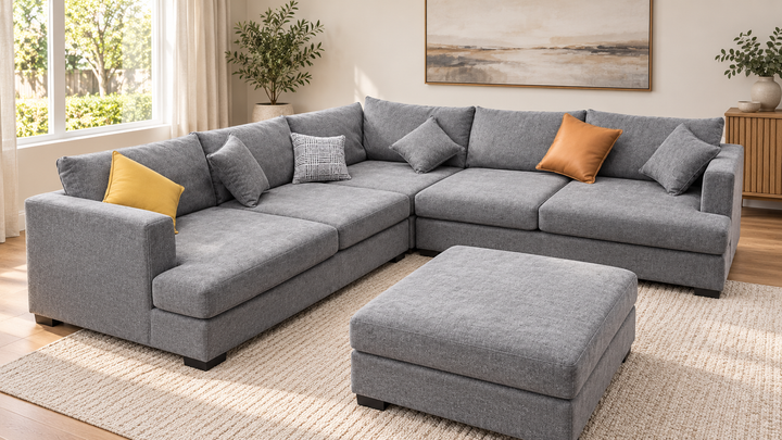 Sophie corner sofa with one matching ottoman in a living room — showroom grey upholstery